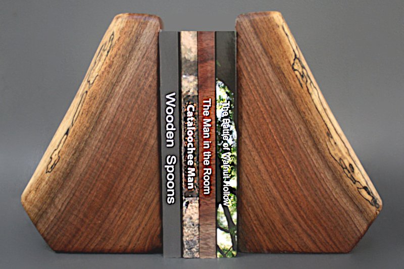 Four Novels Displayed Between 
		Walnut Bookends